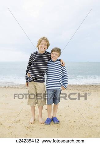 Boys hugging on beach View Large Photo Image Stock Image - Boys hugging on beach. Fotosearch