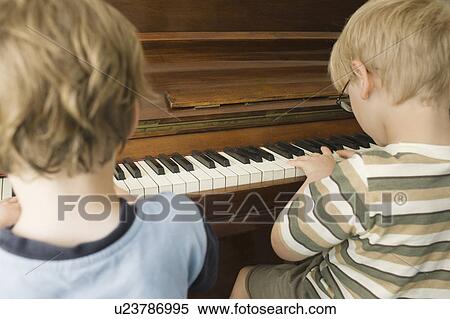 Boys Playing Piano Together View Large Photo Image Stock Photography - Boys Playing Piano Together. Fotosearch