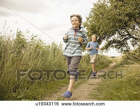 Boys running down path View Large Photo Image Stock Photograph - Boys running down path. Fotosearch
