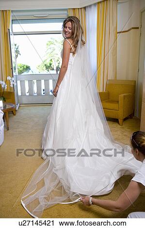 Bride gets dressed View Large Photo Image Stock Image - Bride gets dressed. Fotosearch