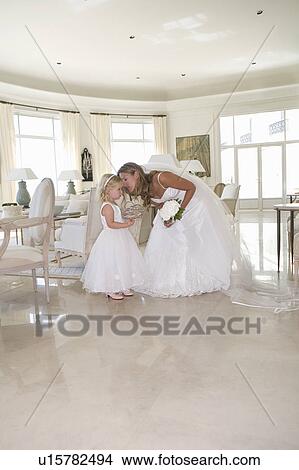 Bride whispers to young flower girl View Large Photo Image Picture - Bride whispers to young flower girl. Fotosearch