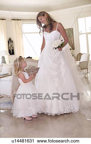 Stock Image - Bride with young flower girl. Fotosearch