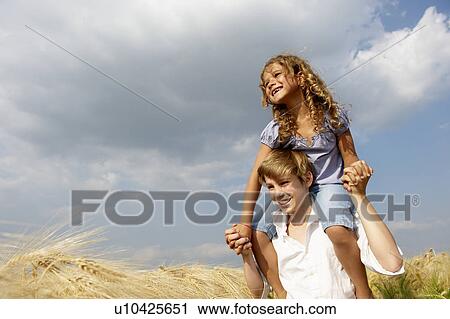 Stock Image - Brother and sister in a wheat field. Fotosearch