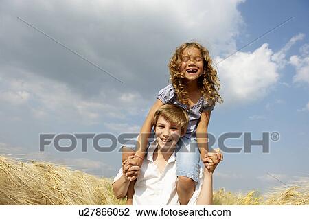 Stock Image - Brother and sister in a wheat field. Fotosearch