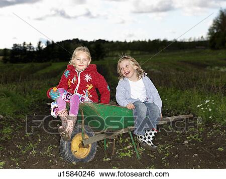 Brother and sister on wheelbarrow View Large Photo Image Stock Photograph - Brother and sister on wheelbarrow. Fotosearch