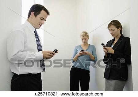 Business colleagues on their phones View Large Photo Image Stock Image - Business colleagues on their phones. Fotosearch