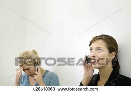 Stock Image - Business colleagues on their phones. Fotosearch