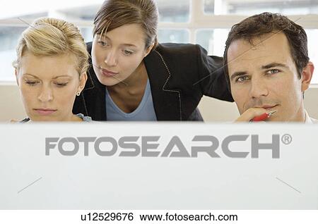 Business colleagues working together View Large Photo Image Stock Photograph - Business colleagues working together. Fotosearch