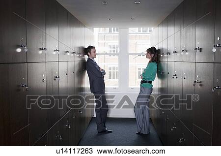 Stock Image - Business couple in locker room. Fotosearch