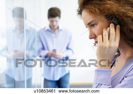 Business man and woman on the phone View Large Photo Image Stock Image - Business man and woman on the phone. Fotosearch