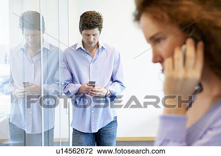 Business man and woman on the phone View Large Photo Image Stock Image - Business man and woman on the phone. Fotosearch
