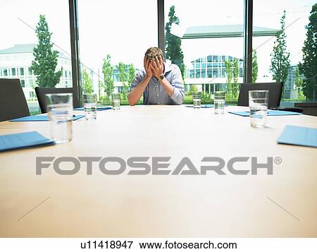 Stock Photo - Business man in a empty conference room. Fotosearch
