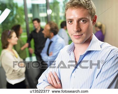 Stock Photo - Business man in the office, smiling. Fotosearch