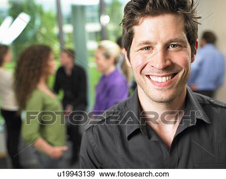 Business man in the office, smiling View Large Photo Image Stock Photo - Business man in the office, smiling. Fotosearch