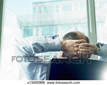 Stock Photograph - Business man looking through window. Fotosearch