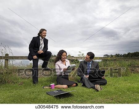 Stock Photography - business meeting in field. Fotosearch