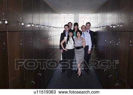 Stock Image - Business people in locker room, portrait. Fotosearch