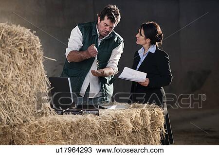Stock Image - business woman advising farmer. Fotosearch