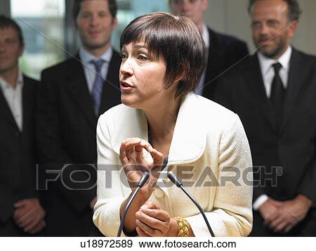 Stock Photo - Business woman giving a conference. Fotosearch