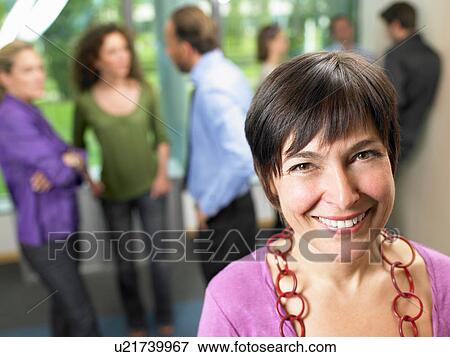 Business woman in the office, smiling View Large Photo Image Stock Photo - Business woman in the office, smiling. Fotosearch