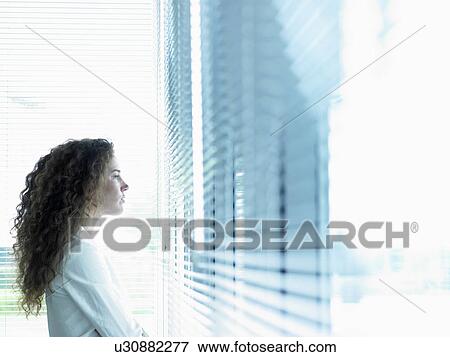 Business woman looking through window View Large Photo Image Stock Photo - Business woman looking through window. Fotosearch