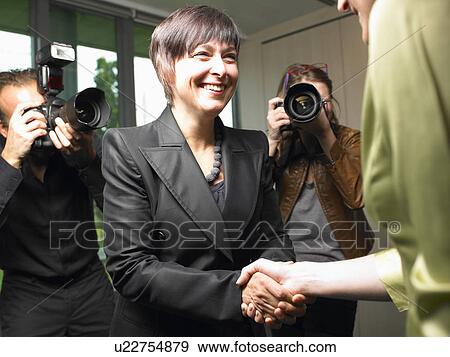 Stock Photo - Business woman shaking hands. Fotosearch