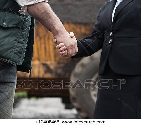 business woman shaking hands with farmer View Large Photo Image Stock Photo - business woman shaking hands with farmer. Fotosearch