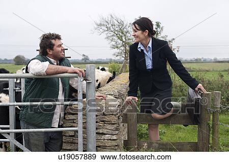 Stock Photo - business woman talking to farmer. Fotosearch