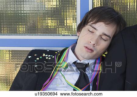 Picture - businessman after party, sleeping. Fotosearch