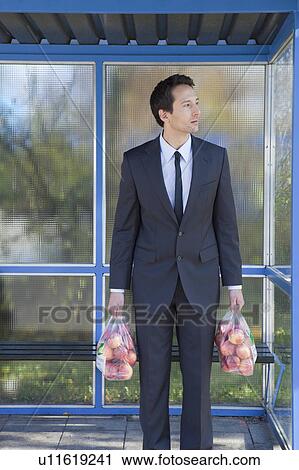 businessman at bus stop, with apples View Large Photo Image Stock Image - businessman at bus stop, with apples. Fotosearch