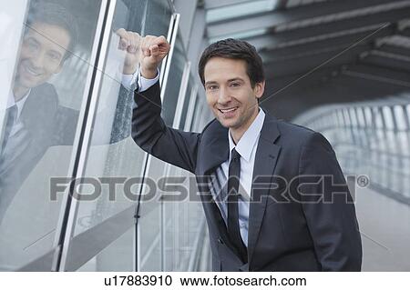 businessman at window pane, happy View Large Photo Image Stock Image - businessman at window pane, happy. Fotosearch