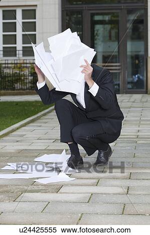 businessman hiding face behind paper View Large Photo Image Stock Photography - businessman hiding face behind paper. Fotosearch