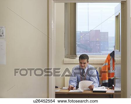 Picture - Businessman In Office At Container Port. Fotosearch