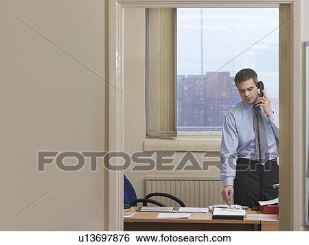 Stock Photograph - Businessman In Office At Container Port. Fotosearch