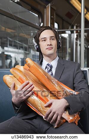 Stock Image - businessman in tube with lot of bread. Fotosearch