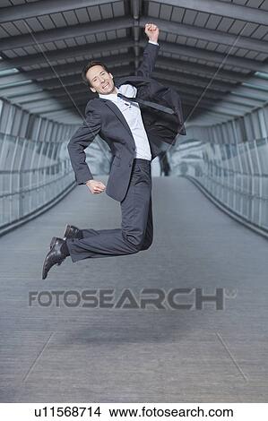 Picture - businessman jumping into air. Fotosearch