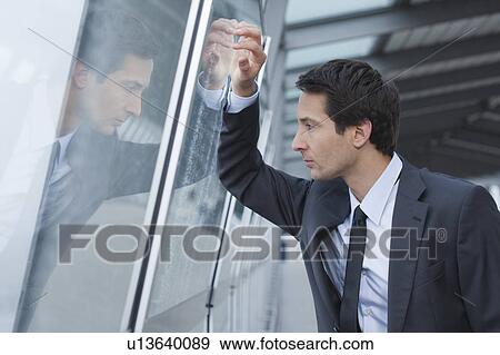 businessman looking out of window View Large Photo Image Stock Photo - businessman looking out of window. Fotosearch