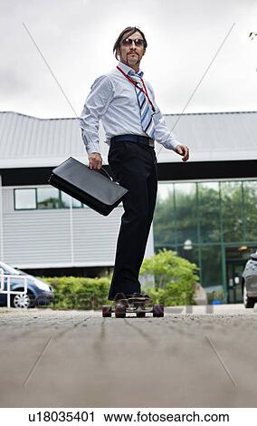 Stock Image - businessman on skateboard. Fotosearch