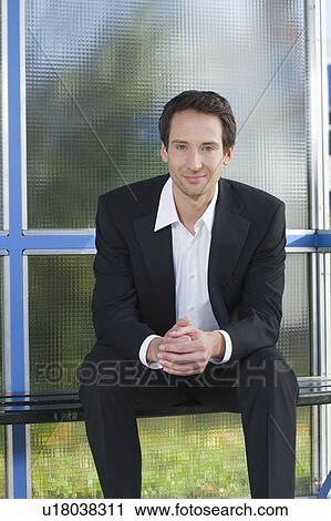 businessman sitting at stop, happy View Large Photo Image Stock Image - businessman sitting at stop, happy. Fotosearch