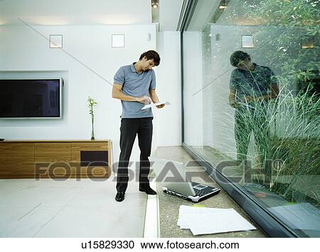 Stock Image - Businessman talks on mobile phone. Fotosearch