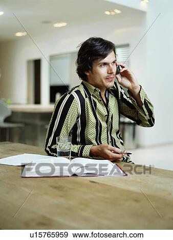 Stock Photo - Businessman talks on mobile phone. Fotosearch