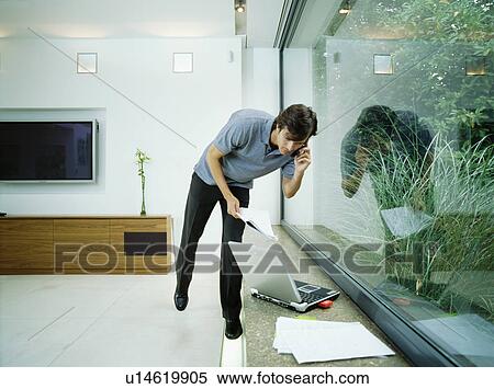 Stock Photography - Businessman talks on mobile phone. Fotosearch