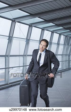 Stock Photo - businessman with case hurrying. Fotosearch