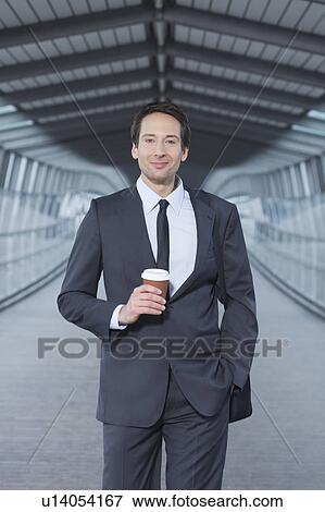 Stock Photo - businessman with coffee to go, happy. Fotosearch
