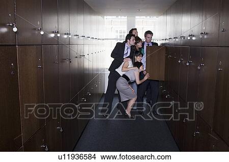 Picture - Businessman with head in locker. Fotosearch