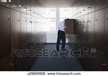 Businessman with head in locker View Large Photo Image Stock Photograph - Businessman with head in locker. Fotosearch