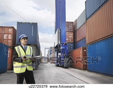 Stock Photo - Businessman With Shipping Containers. Fotosearch