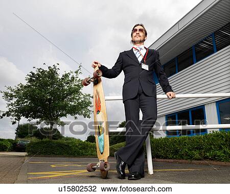 Stock Image - businessman with skateboard. Fotosearch