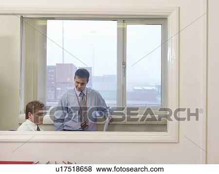 Stock Photo - Businessmen In Office At Container Port. Fotosearch