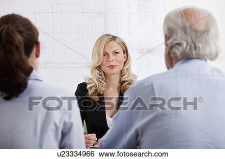 Businesswoman talking to man and woman View Large Photo Image Stock Photograph - Businesswoman talking to man and woman. Fotosearch